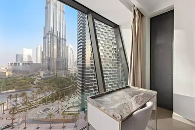 a room with a large window with a view of a city at Luxury 2BR Burj View with Pool Walk to Mall & Metro Dining Shopping in Dubai