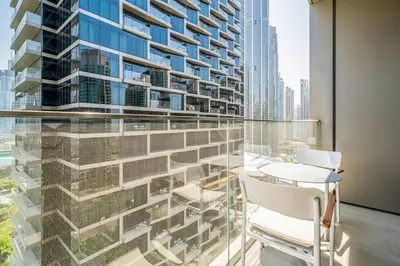 a balcony with a table and chairs and a building at NewArabian Opera Address Residences in Dubai