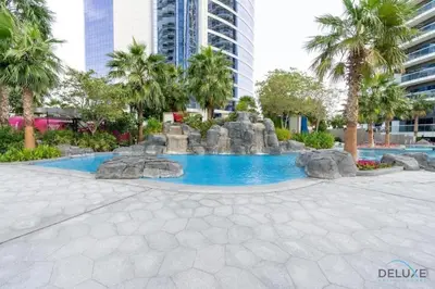 a swimming pool with a fountain in a city at Stylish 1BR in Damac Towers by Paramount B, Business Bay by Deluxe Holiday Homes in Dubai