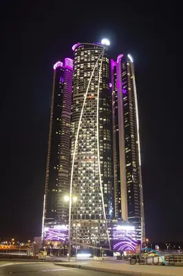 a large building with purple lights on it at night at Stylish 1BR in Damac Towers by Paramount B, Business Bay by Deluxe Holiday Homes in Dubai