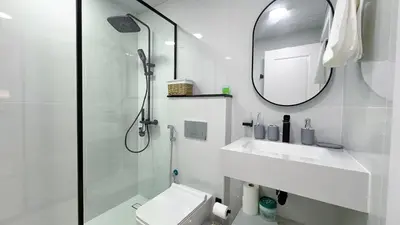 a bathroom with a shower and a toilet and a sink at Dubai Marina - Stylish Studio Apartment - Marina Diamond 2 in Dubai