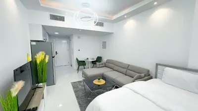 a bedroom with a bed and a couch and a table at Dubai Marina - Stylish Studio Apartment - Marina Diamond 2 in Dubai