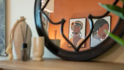 a mirror with a reflection of two girls on a shelf at Stylish 1BR Apartment! Near Metro & Stroll to Dubai Marina in Dubai