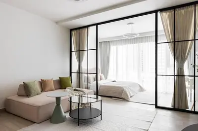 a living room with a couch and a bed at Studio apartment MeDoRe Tower in Dubai