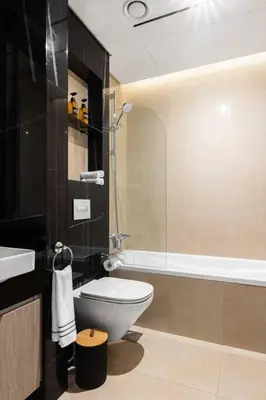 a bathroom with a toilet and a sink and a tub at Studio apartment MeDoRe Tower in Dubai