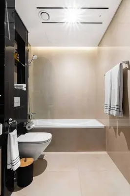 a bathroom with a toilet and a bath tub at Studio apartment MeDoRe Tower in Dubai