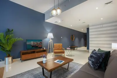 a living room with a couch and a table at Blueground Sheikh Zayed Rd pool gym DXB-462 in Dubai