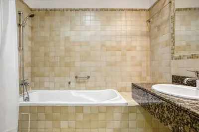 a bathroom with a tub and a sink at Blueground Sadaf sea view elevator gym DXB-925 in Dubai