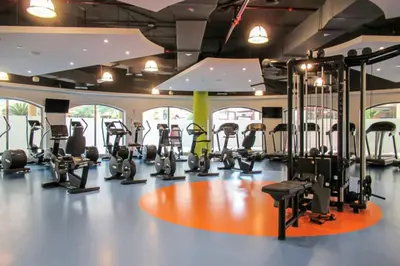 a gym with several treadmills and elliptical machines at Blueground Sadaf sea view elevator gym DXB-925 in Dubai
