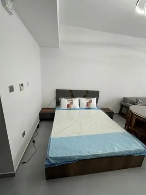 a bedroom with a bed in a white room at Jvc diamond 1 home in Dubai