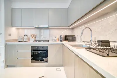 a kitchen with a sink and an oven at Chic 2BR with Iconic Dubai Eye and Palm Views in Dubai