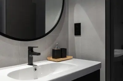 a bathroom sink with a mirror and a soap dispenser at Waves - Stylish 13th-Floor Studio with Top-Notch Amenities in Dubai