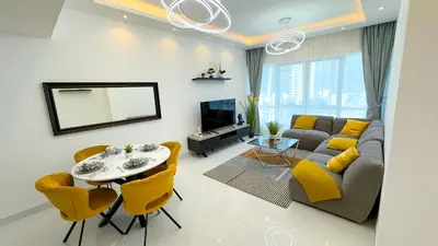 a living room with a couch and a table and yellow chairs at Dubai Marina - 1 BHK Classy Apartment in Dubai