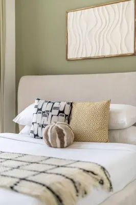 a bed with a blanket and pillows on it at GuestReady - Luxurious paradise in Dubai in Dubai