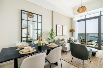 a living room with a dining table and chairs at GuestReady - Luxurious paradise in Dubai in Dubai
