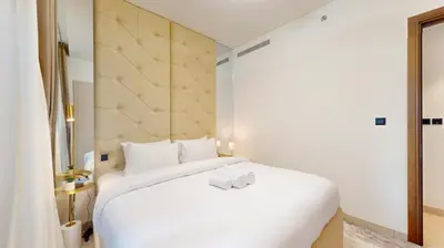 a white bed with two towels on it in a room at Creek Vistas Reserve - Modern One Bedroom in Dubai