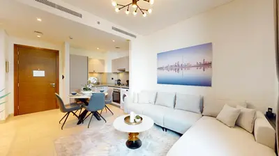 a living room with a white couch and a table at Creek Vistas Reserve - Modern One Bedroom in Dubai