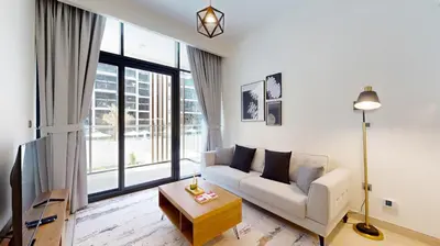 a living room with a couch and a table at Azizi Riviera 18 - Neat One Bedroom in Meydan in Dubai