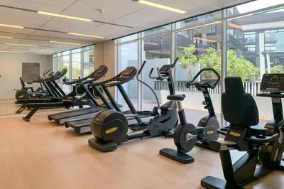 a gym with a bunch of treadms and cardio machines at Belgravia 3 - Bright One Bed with Garden View in Dubai