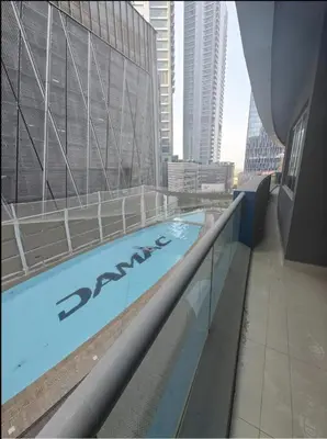 a swimming pool on the side of a building at Luxurious Apartment 500 Meters Next to Dubai Mall in Dubai