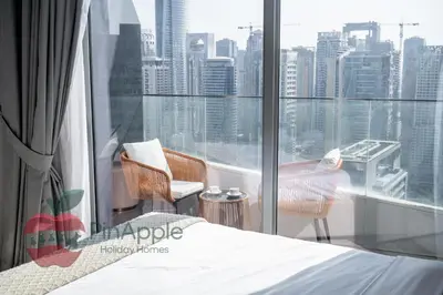 a bedroom with a bed and a view of the city at Lux 1BR Direct access to Dubai Marina 4 people in Dubai