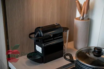 a black toaster sitting on a counter next to a stove at Lux 1BR Direct access to Dubai Marina 4 people in Dubai