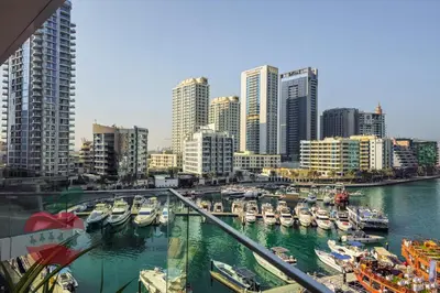a view of a harbor with boats in a city at Lux 1BR Direct access to Dubai Marina 4 people in Dubai