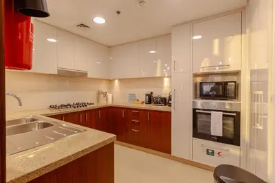a kitchen with a sink and a stove top oven at Dubai Mall Direct Connection Apartment - Burj Vista in Dubai