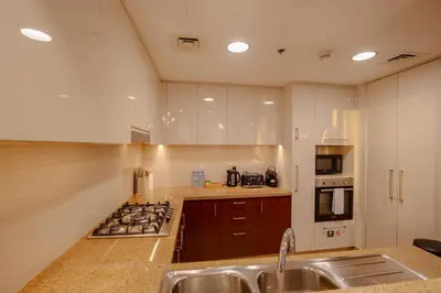 a kitchen with a sink and a stove top oven at Dubai Mall Direct Connection Apartment - Burj Vista in Dubai