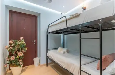 a bedroom with two bunk beds and a door at AWS Holiday Homes - Spectacular Sea Views in Dubai