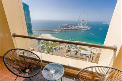a balcony with chairs and a view of the ocean at AWS Holiday Homes - Spectacular Sea Views in Dubai