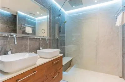 a bathroom with a sink and a mirror and a shower at AWS Holiday Homes - Spectacular Sea Views in Dubai