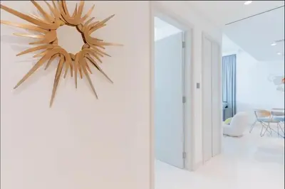 a living room with a mirror on the wall at AWS Holiday Homes - Memories by the Beach in Dubai