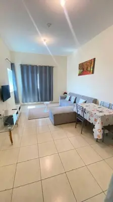 a living room with a couch and a table at Furnished Apartment in Silicon Oasis on Prime Location in Dubai