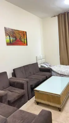 a living room with a couch and a coffee table at Furnished Apartment in Silicon Oasis on Prime Location in Dubai
