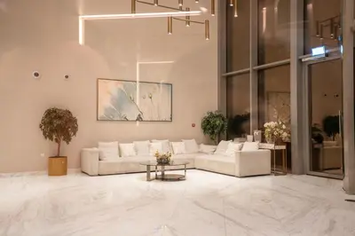 a living room with a couch and a table at CH Urban Haven - 1BR at Boulevard Point with Burj & Fountain Views in Dubai