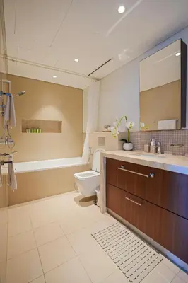 a bathroom with a toilet and a sink and a mirror at CH Urban Haven - 1BR at Boulevard Point with Burj & Fountain Views in Dubai