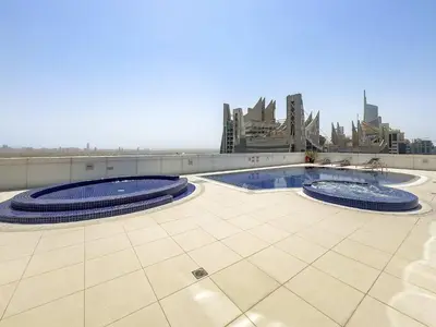 two pools on the roof of a building at Silkhaus Modern Studio in Reef Residence at JVC in Dubai