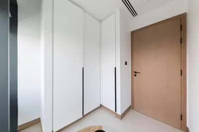 a hallway with white cabinets and a door at Vida Dubai Marina Residences in Dubai