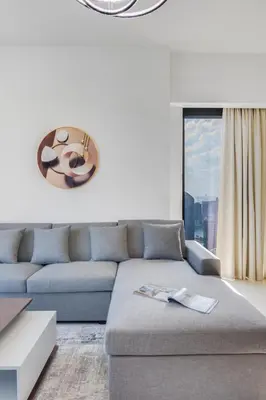 a living room with a couch and a large window at Luxurious 2BDR Apartment with Burj Khalifa Views in Dubai