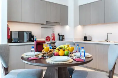 a kitchen with a table with fruit on it at Luxurious 2BDR Apartment with Burj Khalifa Views in Dubai
