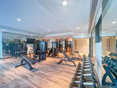 a gym with treadmills and machines in a room at Luxurious 2BDR Apartment with Burj Khalifa Views in Dubai