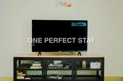 a flat screen tv sitting on top of a table at Cozy 2 Bedroom at JBR Beachfront With Pool And Gym in Dubai
