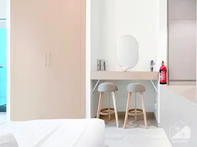 a bedroom with a vanity with two stools and a mirror at Cozy Studio with Balcony & Stunning Views in Dubai