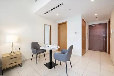 a dining room with a table and chairs at JuliusHomes - Studio in Bay Square, Business Bay Dubai in Dubai