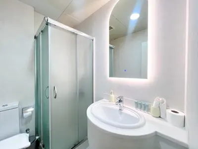 a white bathroom with a sink and a shower at Stunning 2BR In Dubai Marina With Amazing views in Dubai