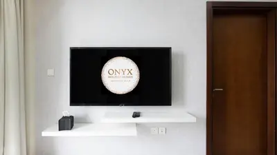 a television with a baseball on a wall at Luxury 2BR apartment with Burj View GYM & Pool in Dubai