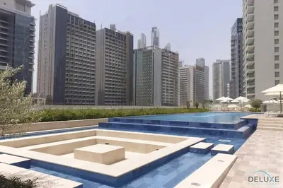a pool in the middle of a city with tall buildings at Luxury 2BR apartment with Burj View GYM & Pool in Dubai