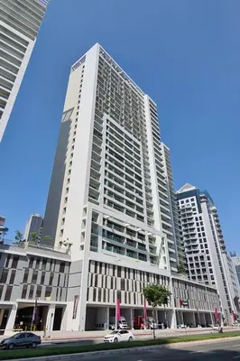 a large white building with cars parked in front of it at Luxury 2BR apartment with Burj View GYM & Pool in Dubai