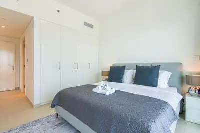 a bedroom with a large bed with blue pillows at Luxurious 2BR in Downtown Views II, Zaabeel Second in Dubai